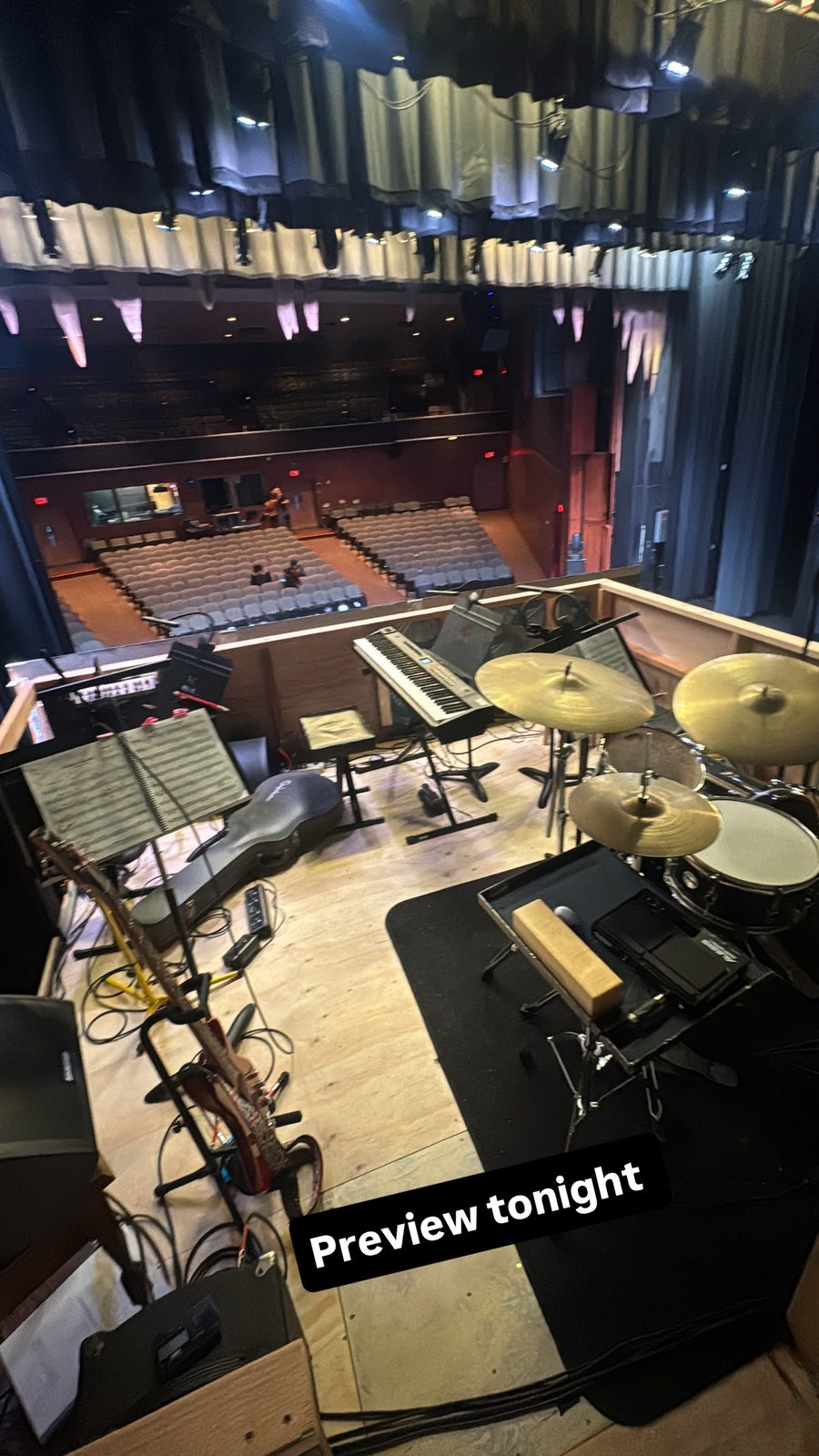 Empty stage setup with instruments at a loft venue, preview lighting