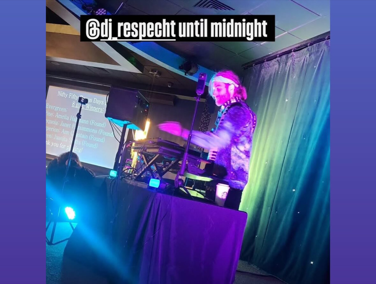 DJ R3$pecht performing under colorful stage lighting