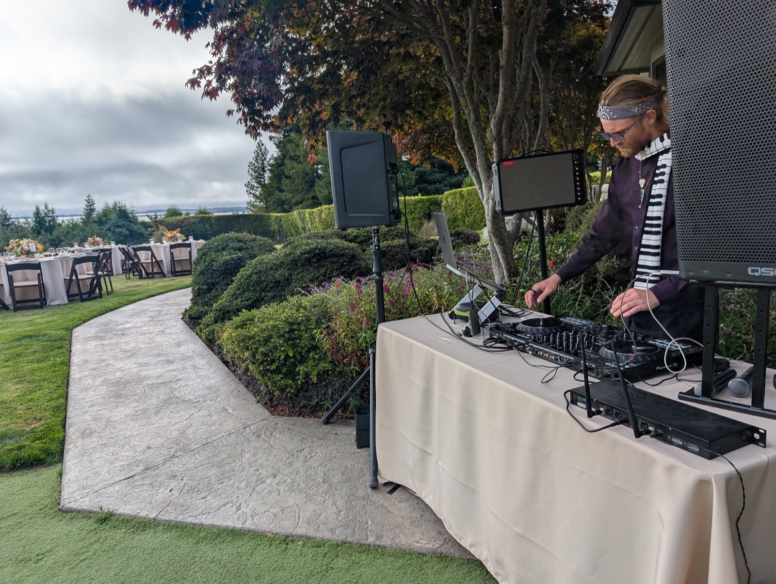 Kieran Specht running full sound and DJ setup at an outdoor Humboldt County wedding