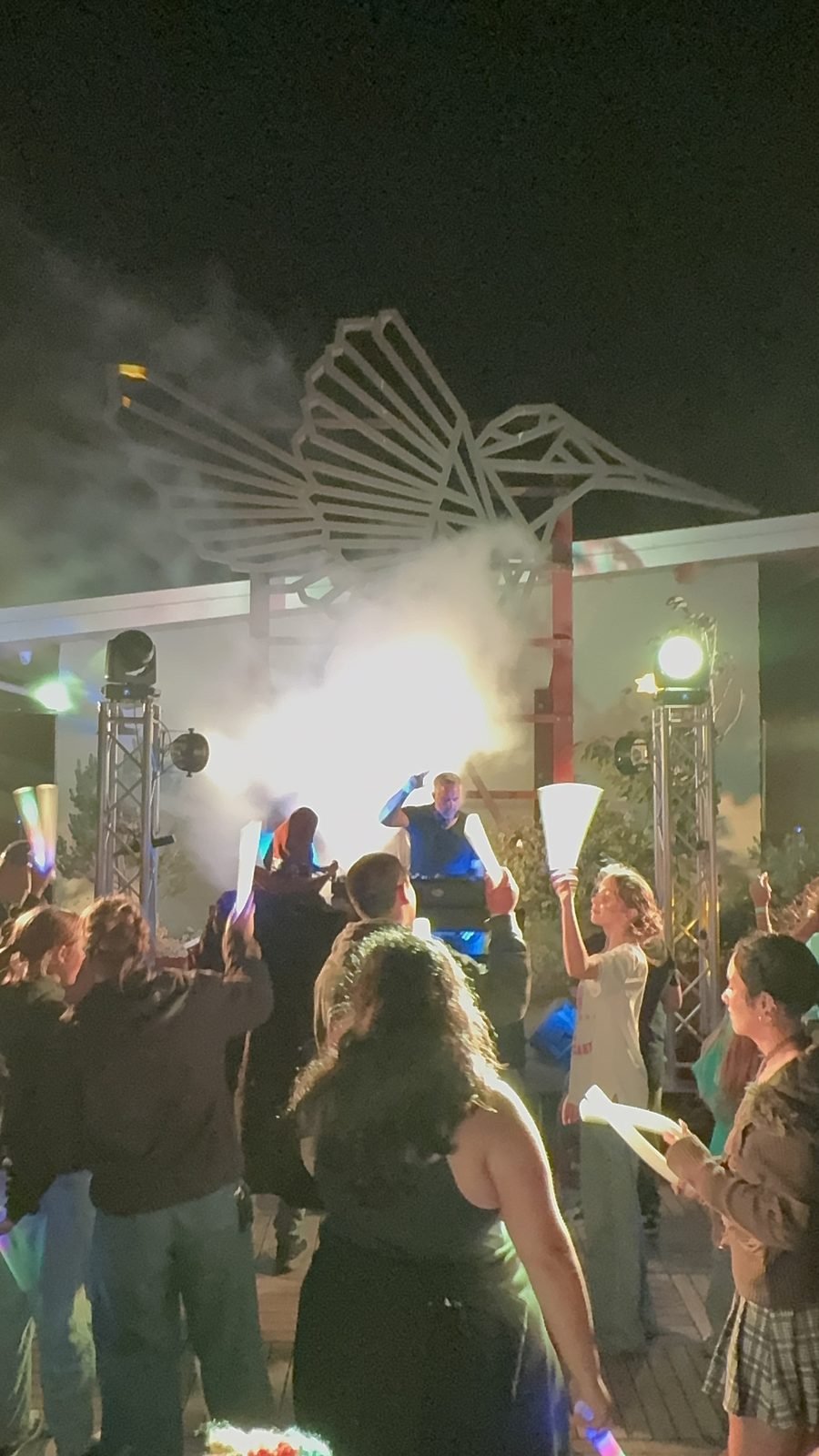 Crowd with glow sticks and smoke effects at the Rooftop SOBE Rave