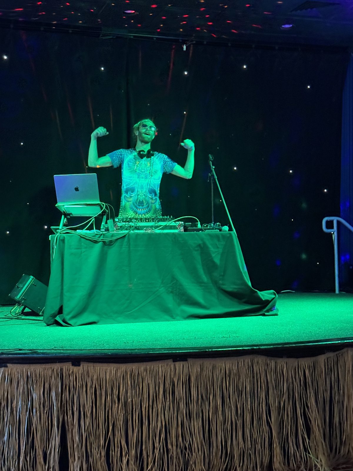 DJ R3$pecht performing at the Blue Lake Wave Lounge under green stage lighting